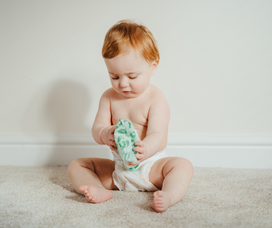 Baby holding pack of eco baby wipes